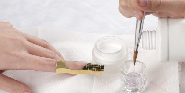 Manicurist treating customer's nails at the beauty salon.Manicure treatment